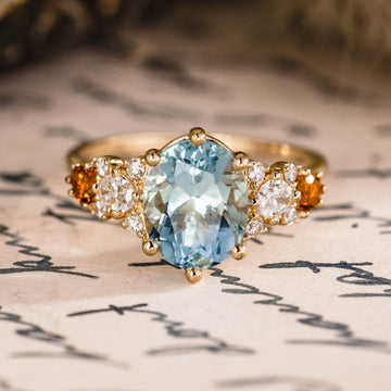 Custom oval aquamarine engagement ring with matching contour band and citrine stones