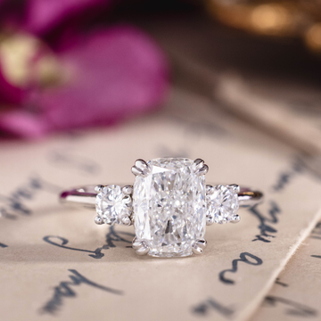 Custom white gold cushion cut three stone diamond engagement ring