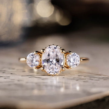 oval-diamond-three-stone-engagement-ring-round-diamond-accents-trilogy-the-wren-rustic-and-main