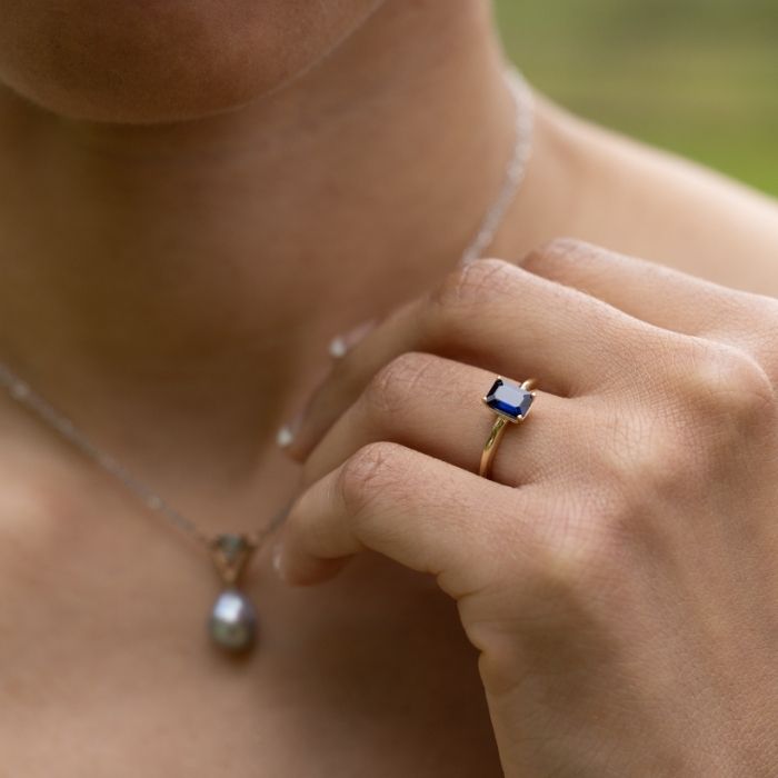 woman-wearing-The-Grace-Emerald-Cut-Blue-Sapphire-Engagement-Ring