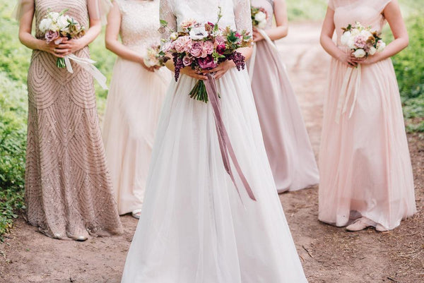bride with bridesmaids holding bouquets