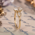 Oval diamond three-stone engagement ring with pear accents in 14K yellow gold