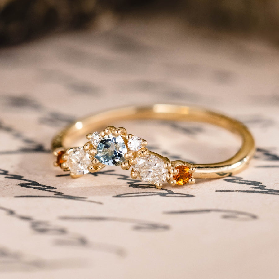 Custom oval aquamarine engagement ring with matching contour band and citrine stones