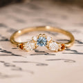Custom oval aquamarine engagement ring with matching contour band and citrine stones