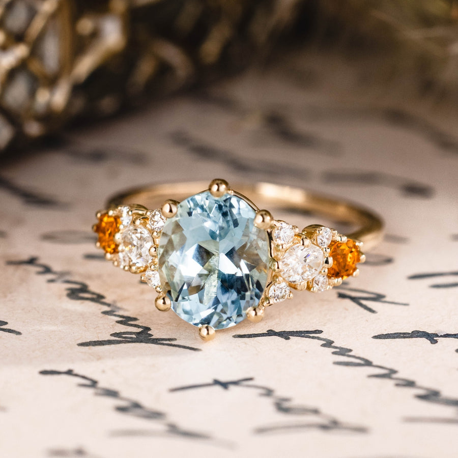 Custom oval aquamarine engagement ring with matching contour band and citrine stones