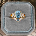 Custom oval aquamarine engagement ring with matching contour band and citrine stones