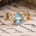 Custom oval aquamarine engagement ring with matching contour band and citrine stones