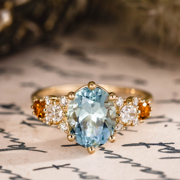 Custom oval aquamarine engagement ring with matching contour band and citrine stones