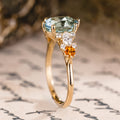 Custom oval aquamarine engagement ring with matching contour band and citrine stones