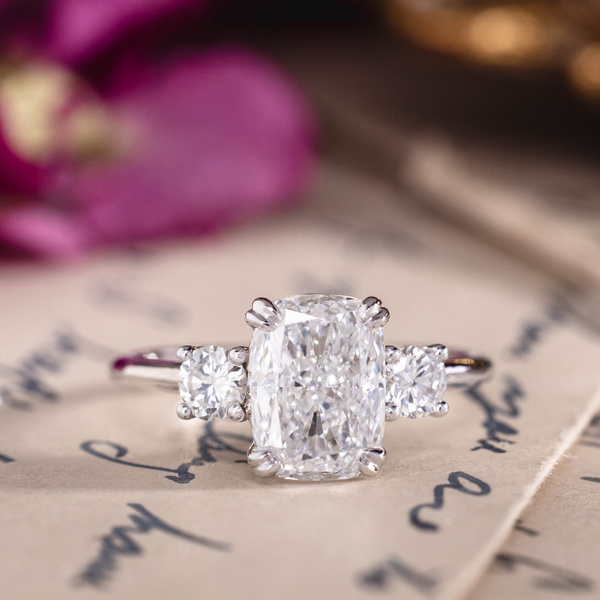 Custom white gold cushion cut three stone diamond engagement ring