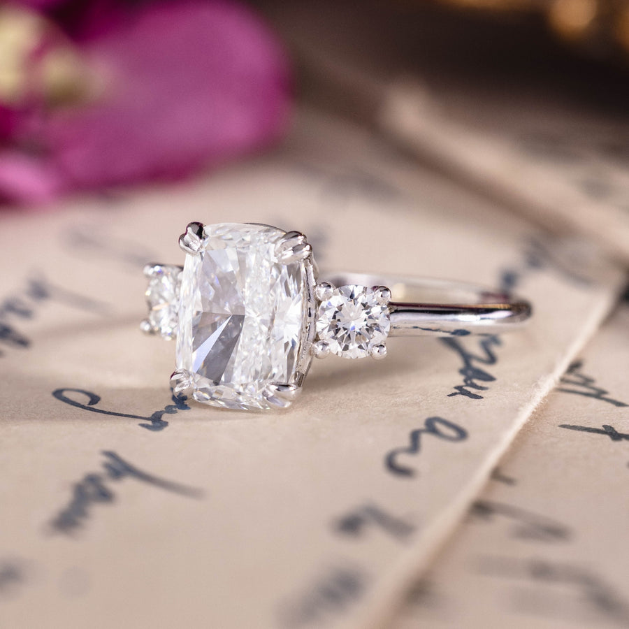 Custom white gold cushion cut three stone diamond engagement ring