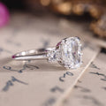 Custom white gold cushion cut three stone diamond engagement ring