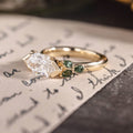 Custom east-west dutch marquise with green sapphire side stones