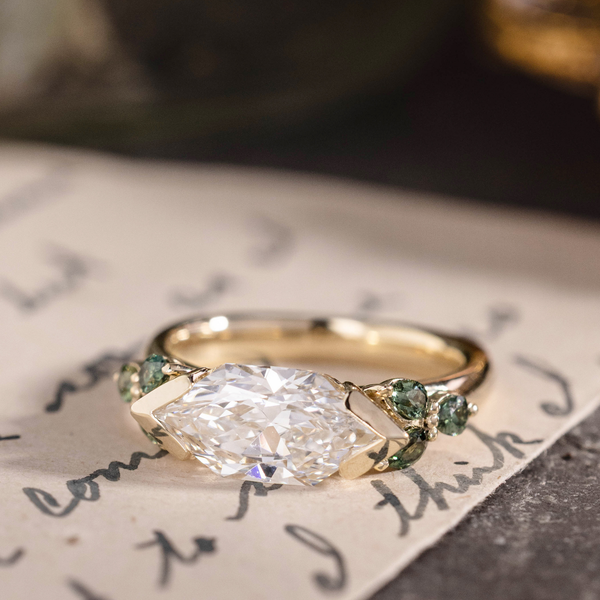 Custom east-west dutch marquise with green sapphire side stones