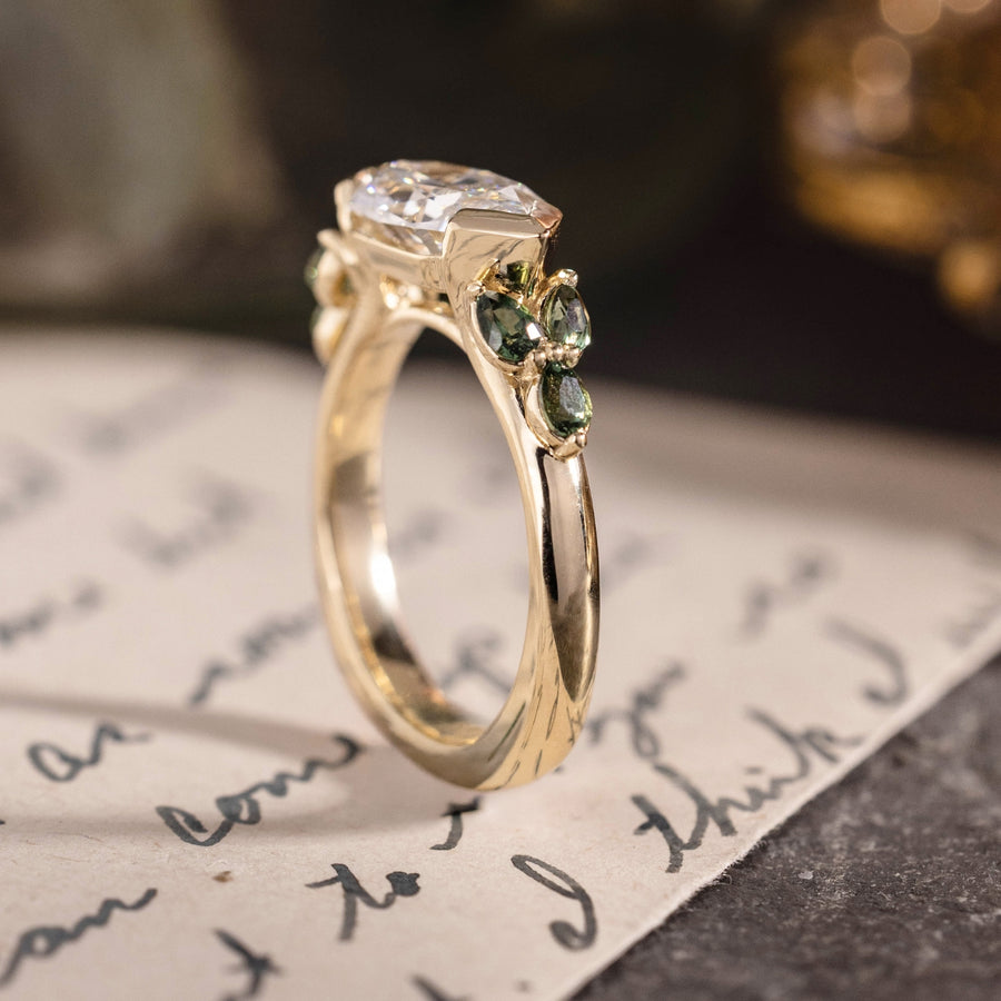 Custom east-west dutch marquise with green sapphire side stones