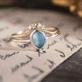 Custom floral contour band with diamonds and sea glass engagement ring