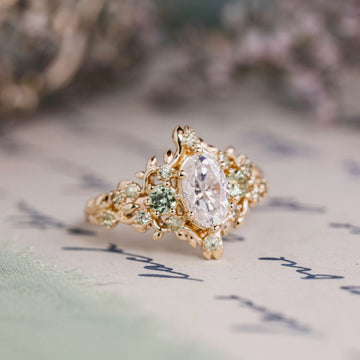 Custom Floral Vine–Inspired Oval Moissanite Engagement Ring with Green Sapphire Accents