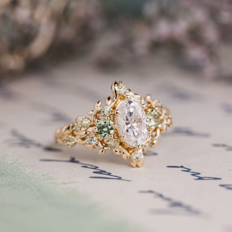 Custom Floral Vine–Inspired Oval Moissanite Engagement Ring with Green Sapphire Accents