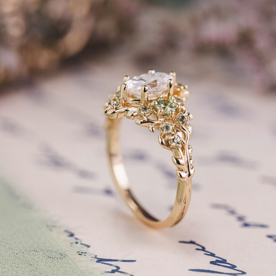 Custom Floral Vine–Inspired Oval Moissanite Engagement Ring with Green Sapphire Accents