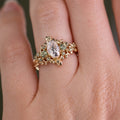 Custom Floral Vine–Inspired Oval Moissanite Engagement Ring with Green Sapphire Accents