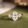 Custom three stone oval diamond engagement ring with trillion cut diamonds