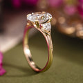 Custom three stone oval diamond engagement ring with trillion cut diamonds