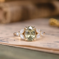 Oval green sapphire engagement ring with marquise diamond accents in 14K yellow gold