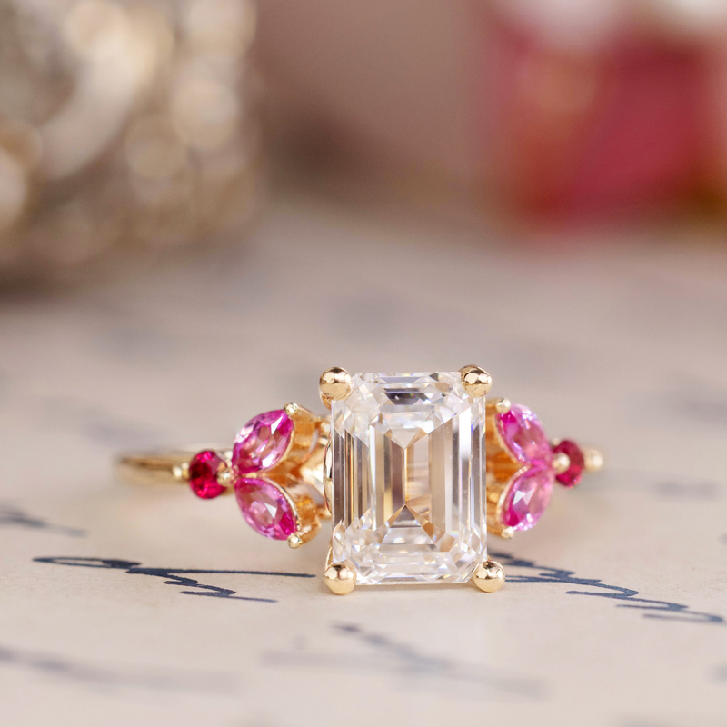 Emerald cut diamond engagement ring with pink sapphire cluster accents