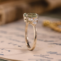 Oval green sapphire engagement ring with marquise diamond accents in 14K yellow gold