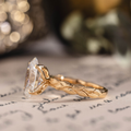 Oval lab-grown diamond engagement ring in 14K yellow gold with hand-engraved leaf band