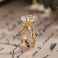 Oval lab-grown diamond engagement ring in 14K yellow gold with hand-engraved leaf band
