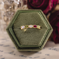 Vintage marquise family ring with ruby, tanzanite, peridot, tourmaline, and diamond accents in 18K yellow gold