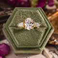 Three-stone custom diamond engagement ring with oval center