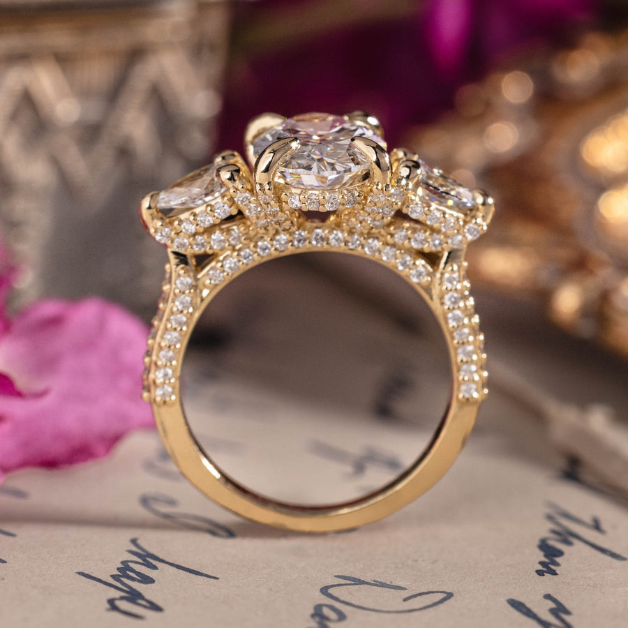 Three-stone custom diamond engagement ring with oval center