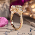 Three-stone custom diamond engagement ring with oval center
