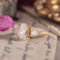 Three-stone custom diamond engagement ring with oval center
