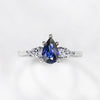 The Diana - Blue Sapphire Pear Cut Three Stone Engagement Ring with Diamond Accents