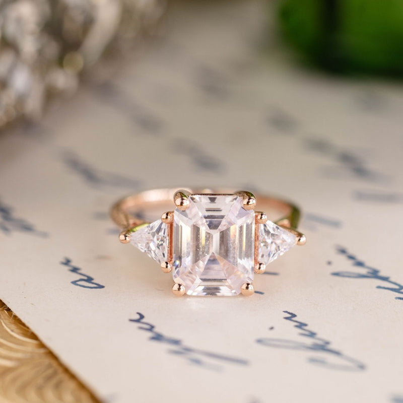 Emerald-cut-diamond-three-stone-engagement-ring-trillion-diamond-accent-stones-the-ingrid-rustic-and-main