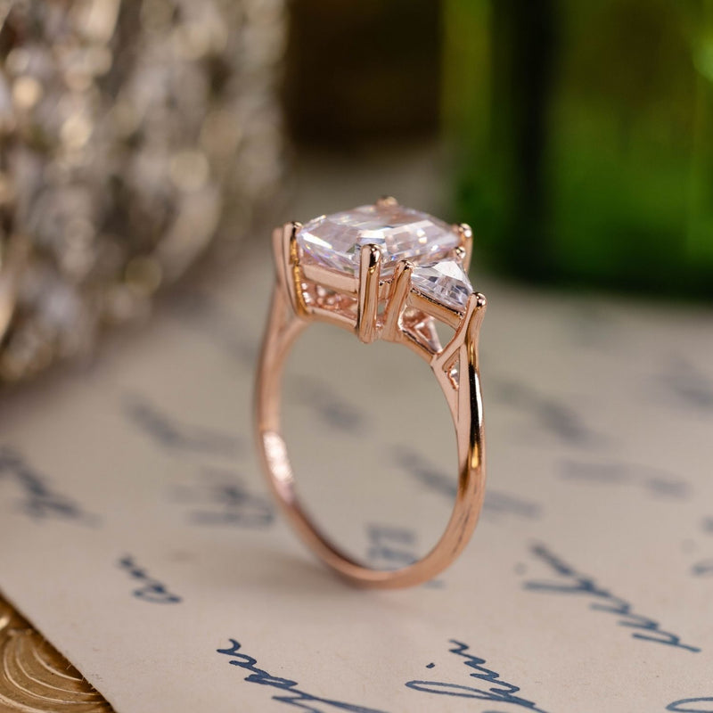 Emerald-cut-diamond-three-stone-engagement-ring-trillion-diamond-accent-stones-the-ingrid-rustic-and-main
