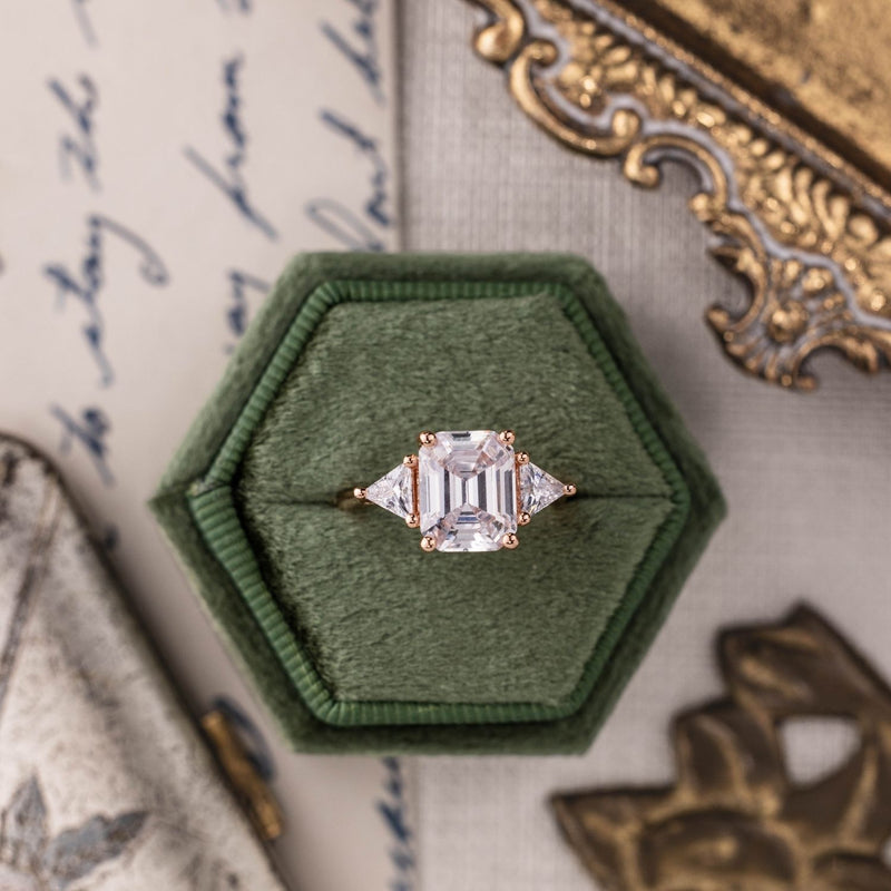 Emerald-cut-diamond-three-stone-engagement-ring-trillion-diamond-accent-stones-the-ingrid-rustic-and-main
