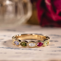 Vintage marquise family ring with ruby, tanzanite, peridot, tourmaline, and diamond accents in 18K yellow gold