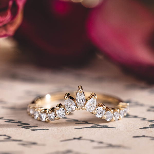 Contour wedding band with marquise, pear, and round diamond accents in 10K yellow gold