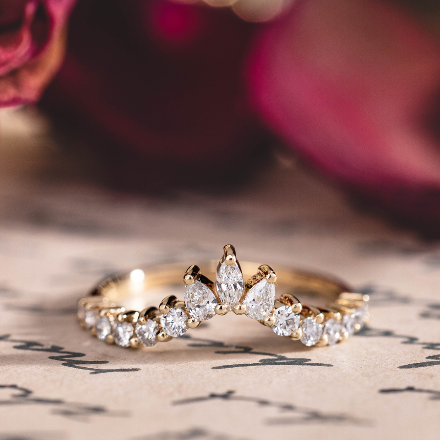 Contour wedding band with marquise, pear, and round diamond accents in 10K yellow gold