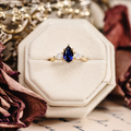 Pear cut lab-grown blue sapphire engagement ring with diamond accents in 14K yellow gold