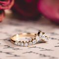 Contour wedding band with marquise, pear, and round diamond accents in 10K yellow gold