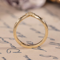 Chevron wedding band with round and baguette diamond accents in 14K yellow gold