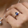 blue-sapphire-pear-cut-three-stone-engagement-ring-with-diamond-accents