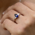 blue-sapphire-pear-cut-three-stone-engagement-ring-with-diamond-accents