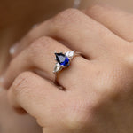 blue-sapphire-pear-cut-three-stone-engagement-ring-with-diamond-accents
