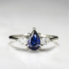 The Diana - Blue Sapphire Pear Cut Three Stone Engagement Ring with Diamond Accents